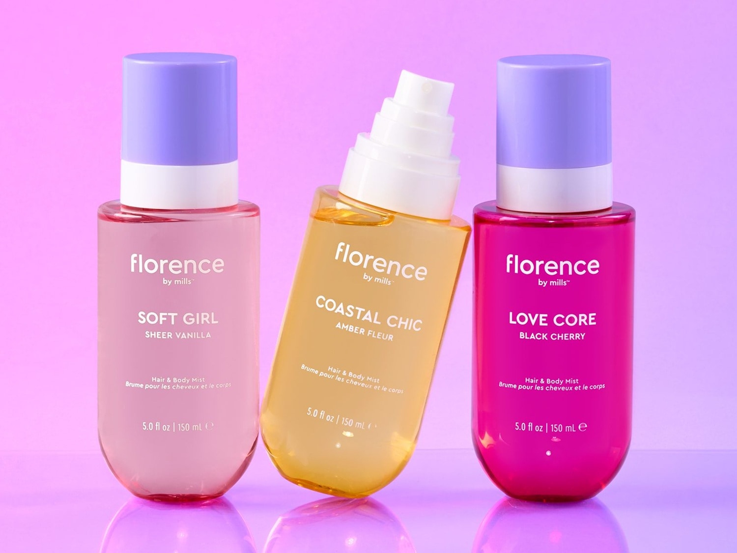 Discover Florence by Mills Hair & Body Mists: Soft Girl Sheer Vanilla in a pink bottle, Coastal Chic Amber Fleur in a yellow bottle, and Love Core Black Cherry in a magenta bottle, each 150 ml with a light purple cap.