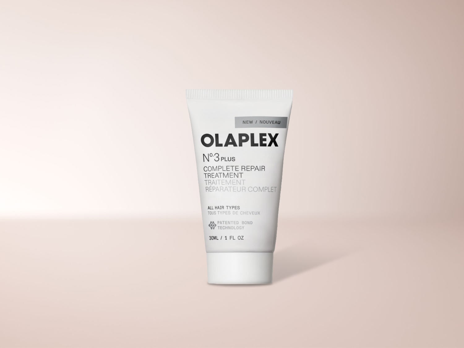 Olaplex N°3 Plus Complete Repair Treatment, eine weiße Tube mit schwarzer und grauer Schrift, die für alle Haartypen geeignet ist und 30 ml enthält.