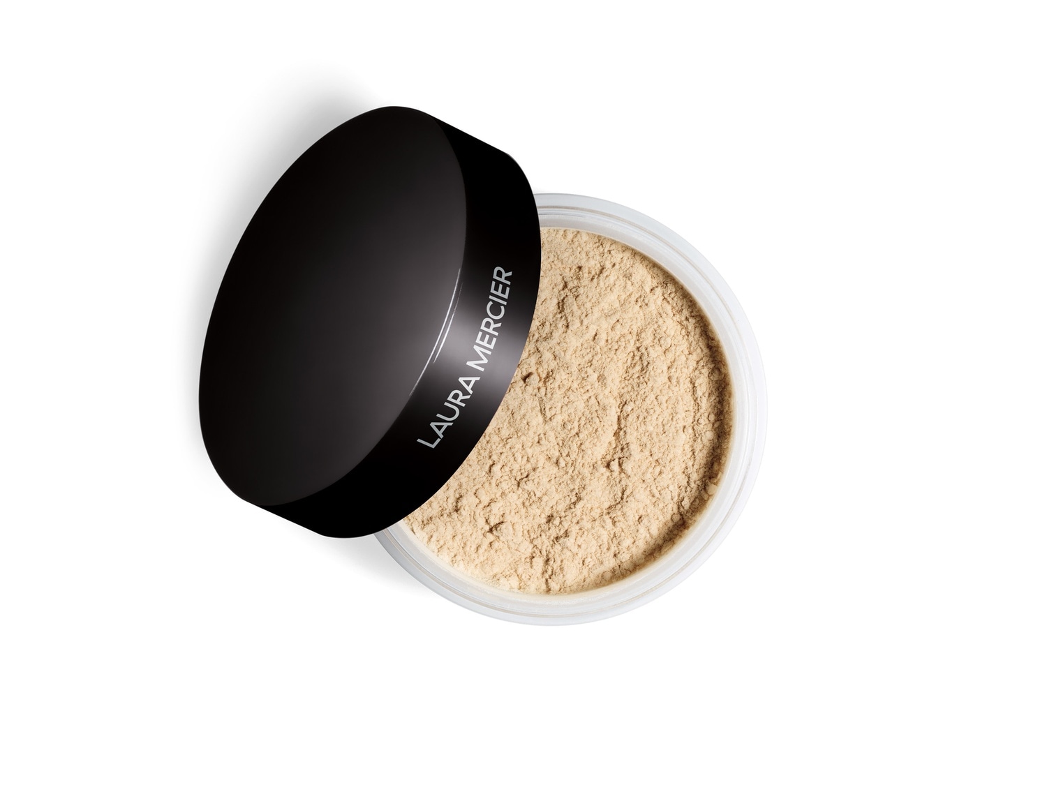 Puder sypki Laura Mercier w przezroczystym słoiczku z czarną zakrętką, leżącą obok, ukazujący beżowy odcień produktu.