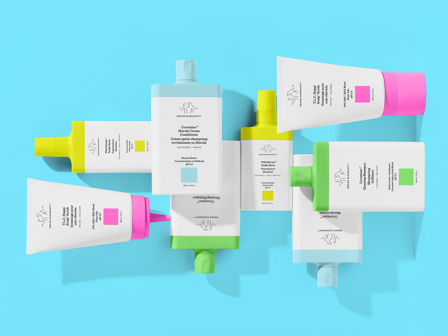 Ontdek de Drunk Elephant haarverzorgingslijn: kleurrijke flessen met shampoo, conditioner, tangle spray en hoofdhuid scrub voor een complete haarverzorgingsroutine.