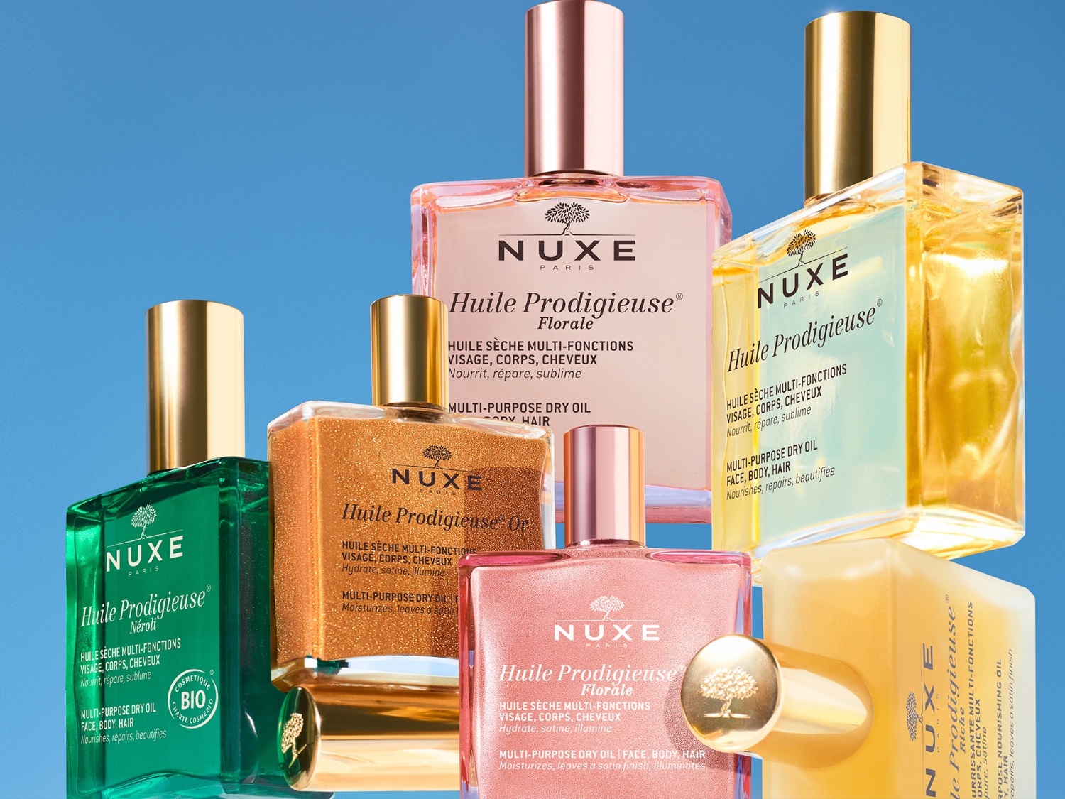 Eine Sammlung von Nuxe Huile Prodigieuse Trockenölen in verschiedenen Varianten, darunter Florale, Or und Néroli, die Gesicht, Körper und Haar nähren, reparieren und verfeinern.