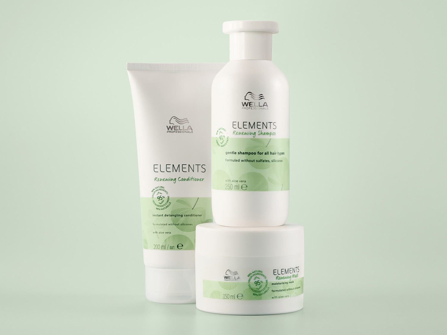 Kolekcja Wella Professionals Elements: odżywka, szampon i maska do włosów w białych opakowaniach z zielonymi akcentami, zawierające naturalne składniki i aloes.