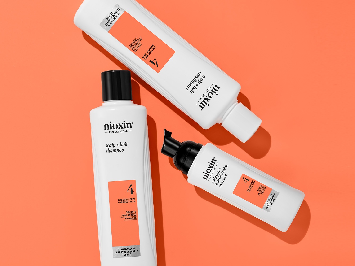 Zestaw Nioxin Pro Clinical do włosów farbowanych, suchych i zniszczonych, obejmujący szampon, odżywkę i kurację zagęszczającą włosy, testowany klinicznie i dermatologicznie.