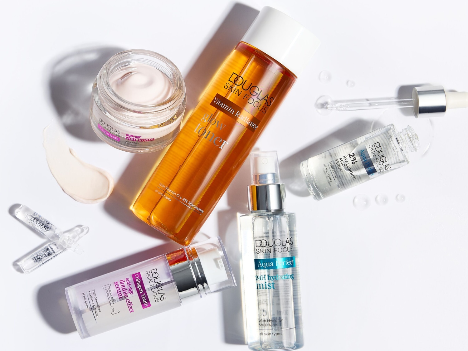 Odkryj Douglas Skin Focus Anti-Age Rich Cream, krem przeciwstarzeniowy w słoiczku, z widoczną obok próbką jego bogatej, kremowej konsystencji.