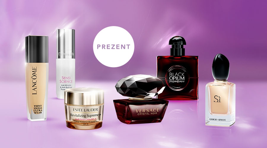 Na fioletowym tle znajdują się produkty do pielęgnacji skóry i perfumy znanych marek, takich jak Lancôme, Estée Lauder, Versace, Yves Saint Laurent i Giorgio Armani, a w tle widnieje napis "PREZENT".