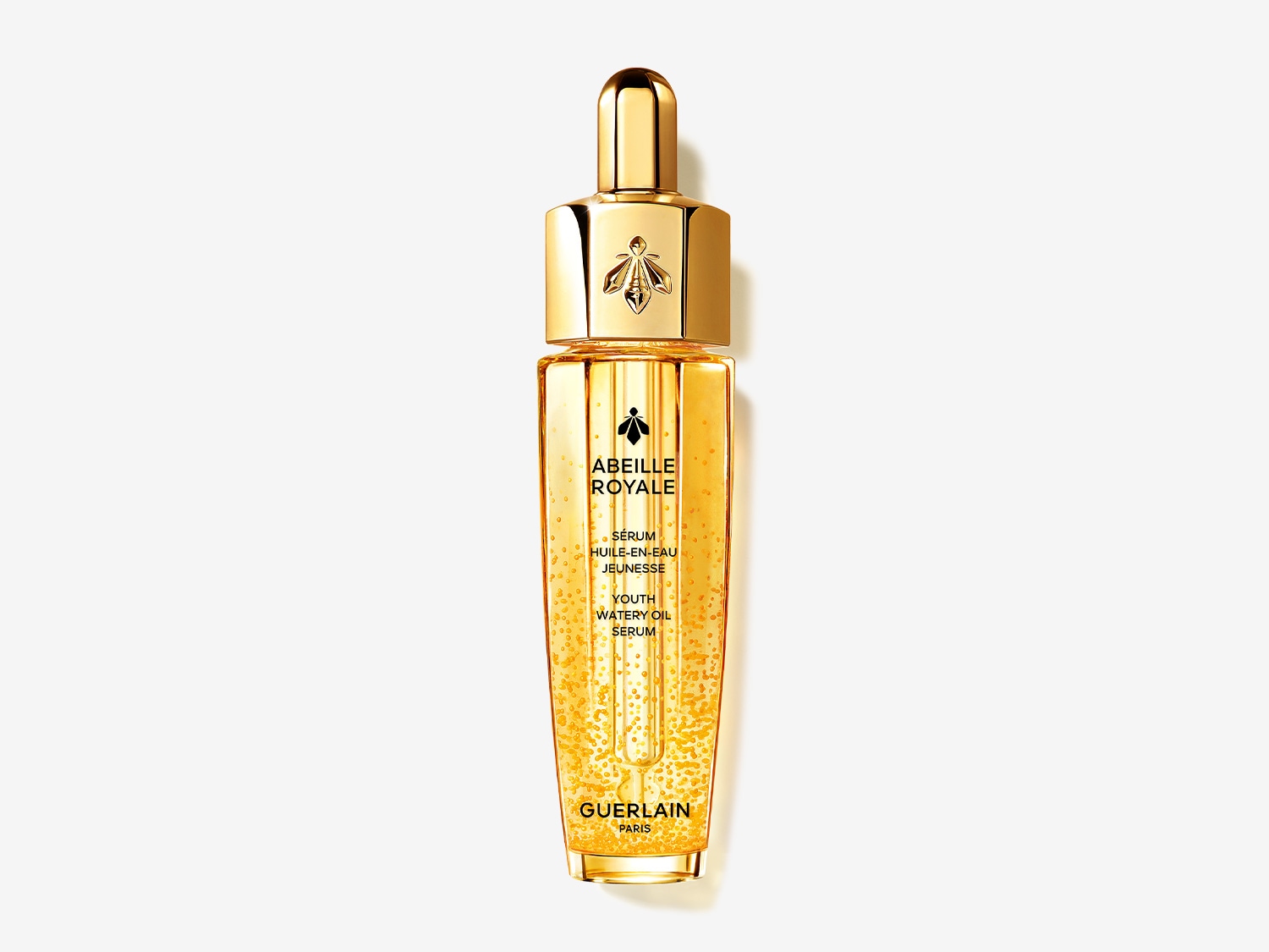Das Guerlain Abeille Royale Youth Watery Oil Serum in einer goldenen Flasche mit Pipette, die eine jugendliche Ausstrahlung verspricht.
