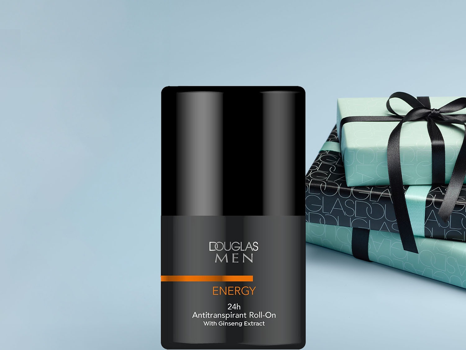 Czarny antyperspirant w kulce Douglas Men Energy 24h z ekstraktem z żeń-szenia, obok ułożone są ozdobne prezenty.