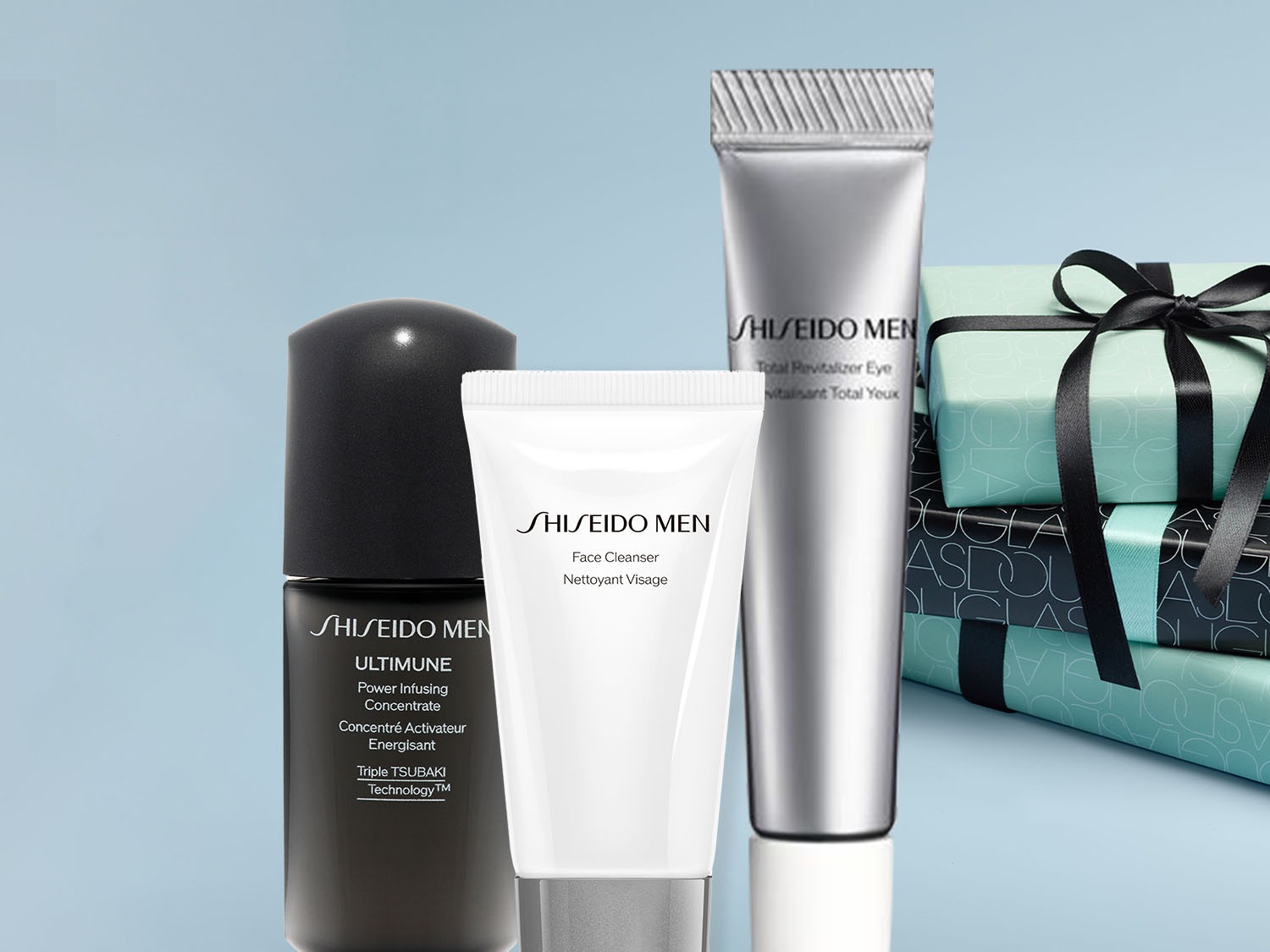 Zestaw kosmetyków Shiseido Men do pielęgnacji twarzy, w tym krem nawilżający, żel oczyszczający i krem pod oczy, obok ułożone są prezenty w turkusowym papierze z czarną wstążką.