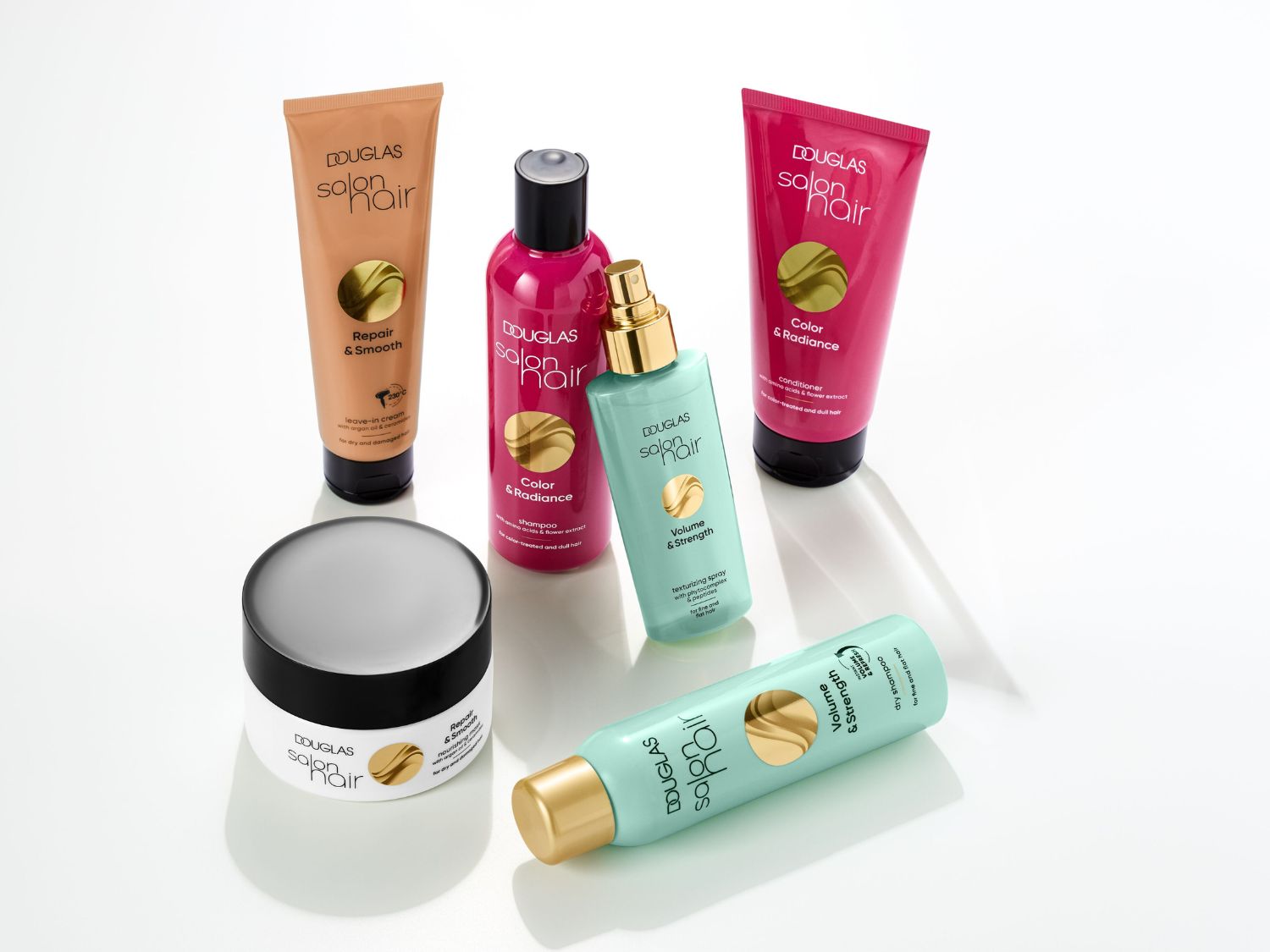 A Douglas Salon Hair termékcsaládja: Repair & Smooth krém, Color & Radiance sampon és kondicionáló, valamint Volume & Strength spray a hajápolásért.