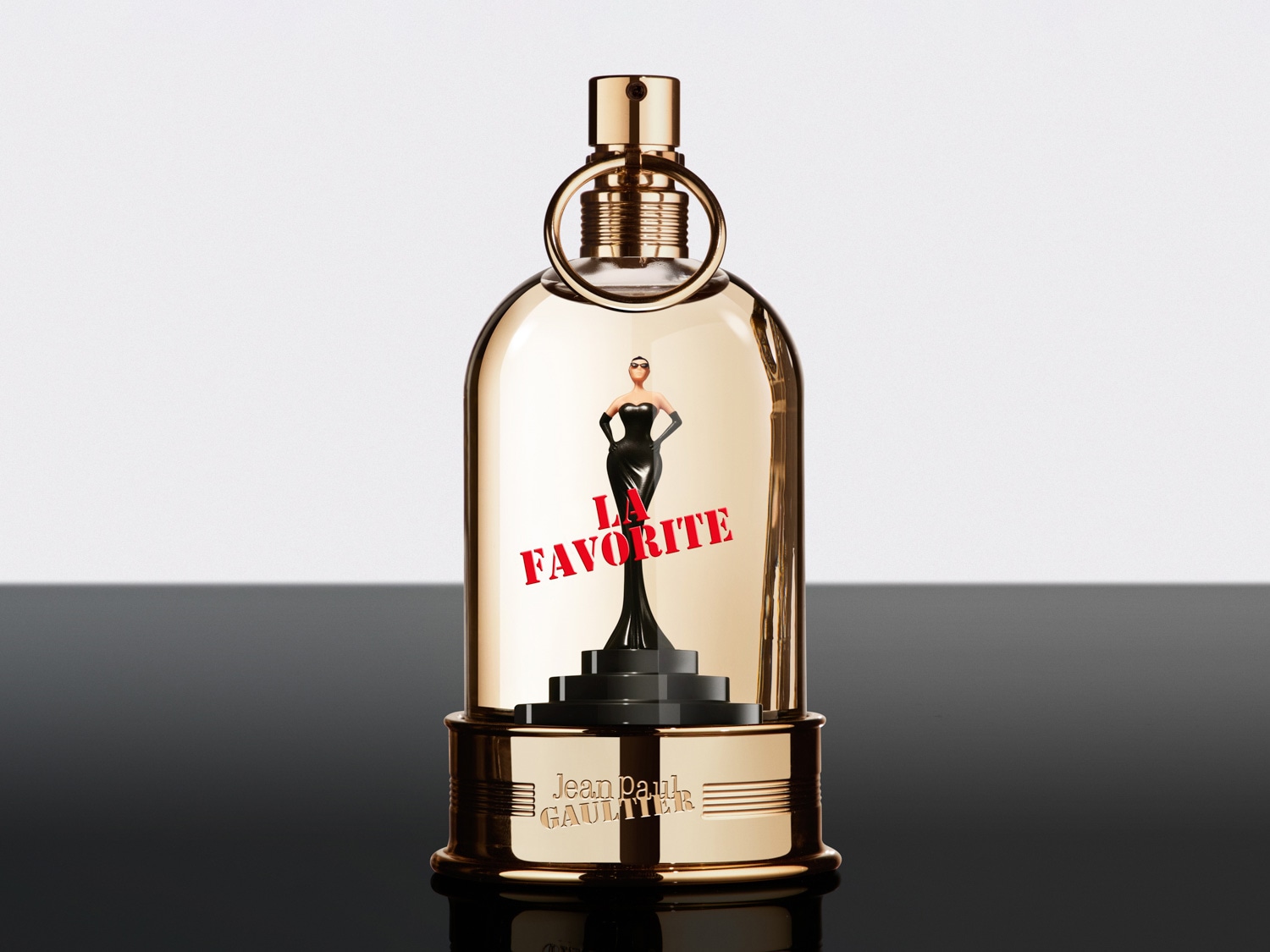Frasco de perfume dorado de Jean Paul Gaultier con una silueta femenina negra en su interior bajo una cúpula de cristal.