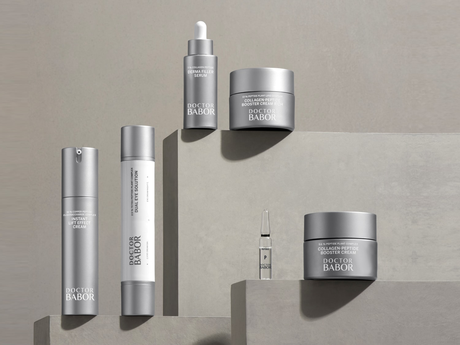 Kolekcja produktów Doctor Babor do pielęgnacji skóry, w srebrnych opakowaniach, obejmuje serum, kremy do twarzy i pod oczy, zapewniające kompleksową pielęgnację.