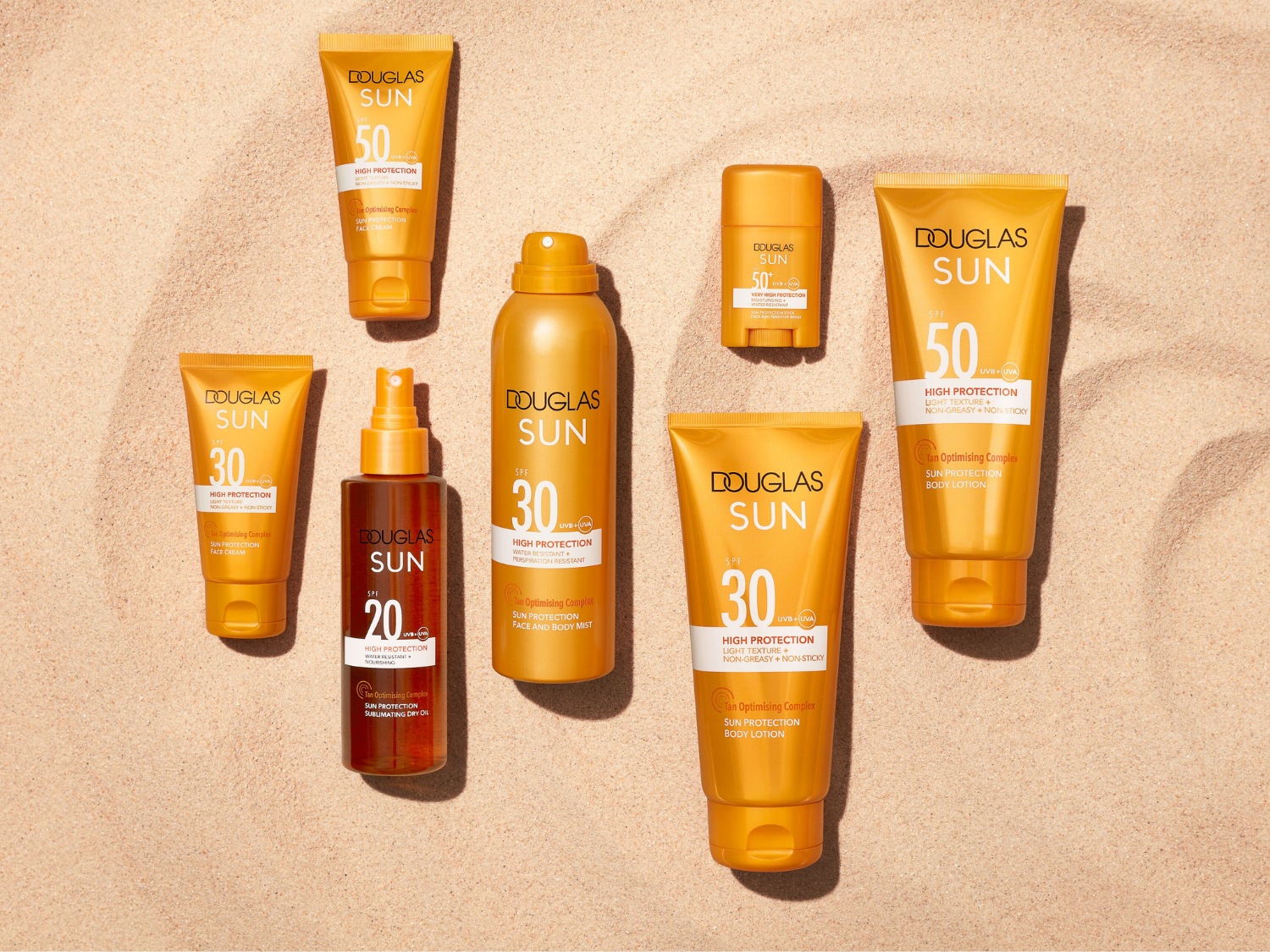 Krem do twarzy Douglas Sun SPF 50 w pomarańczowej tubce, zapewniający wysoką ochronę, z kompleksem optymalizującym opaleniznę, idealny do codziennego użytku.