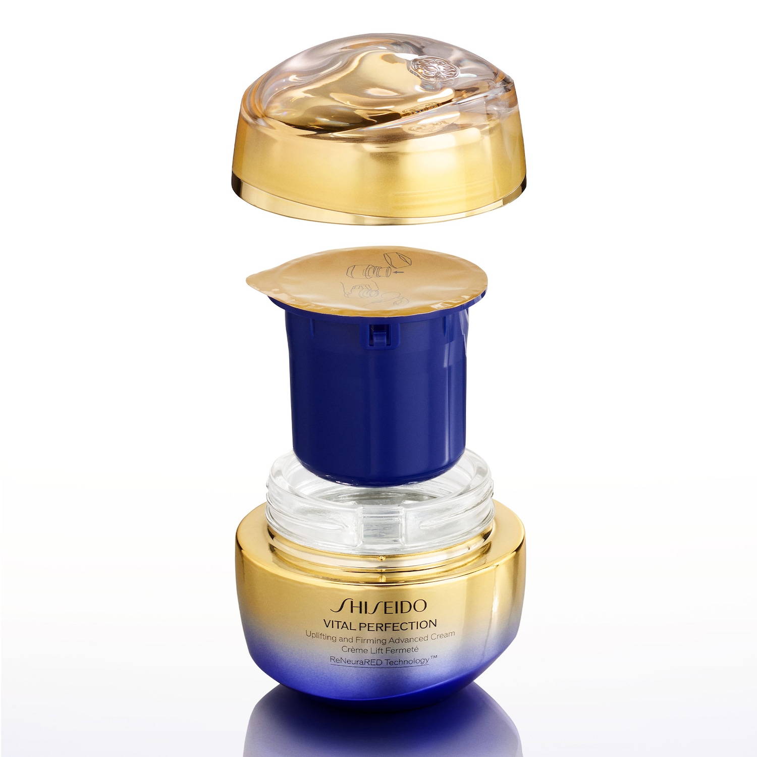 Nahaufnahme der Shiseido Vital Perfection Straffungscreme, die in einer goldenen und blauen Verpackung mit abnehmbarem Deckel und Einsatz präsentiert wird.