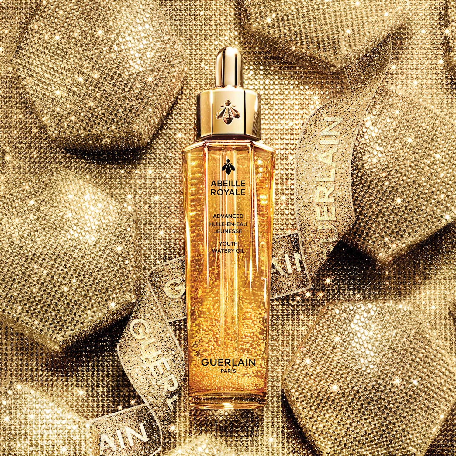 Huile-en-eau jeunesse Abeille Royale de Guerlain dans son flacon doré iconique, promesse d'une peau éclatante et revitalisée.