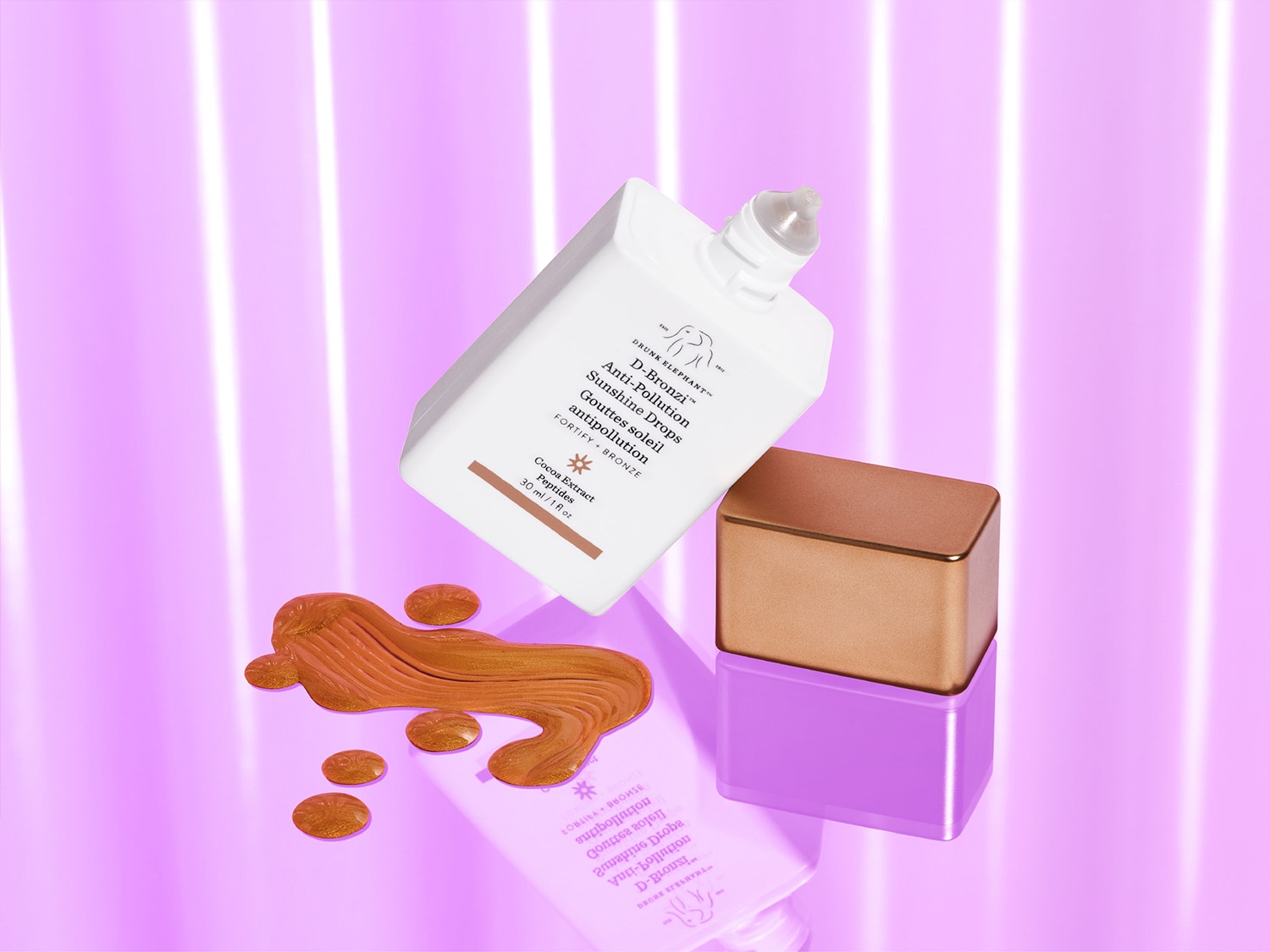 Drunk Elephant D-Bronzi Anti-Pollution Sunshine Drops, eine Formel mit Kakaoextrakt und Peptiden, die die Haut stärkt und ihr einen sonnengeküssten Glow verleiht.