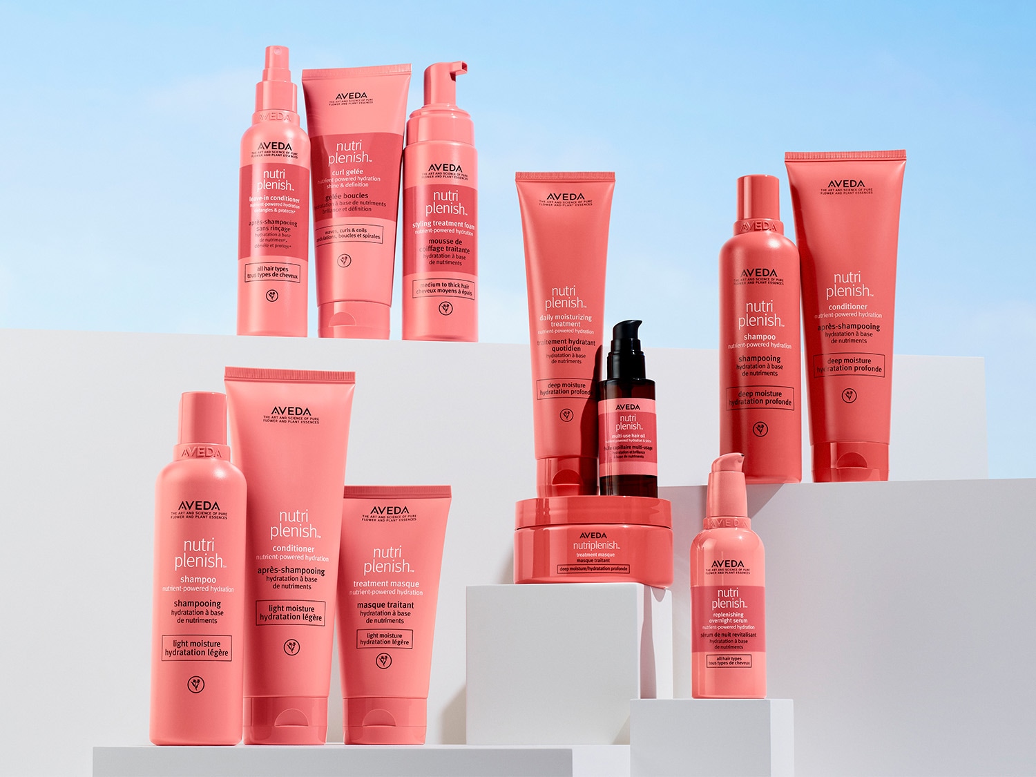 Eine Sammlung von Aveda Nutriplenish Haarpflegeprodukten in rosa Verpackung.