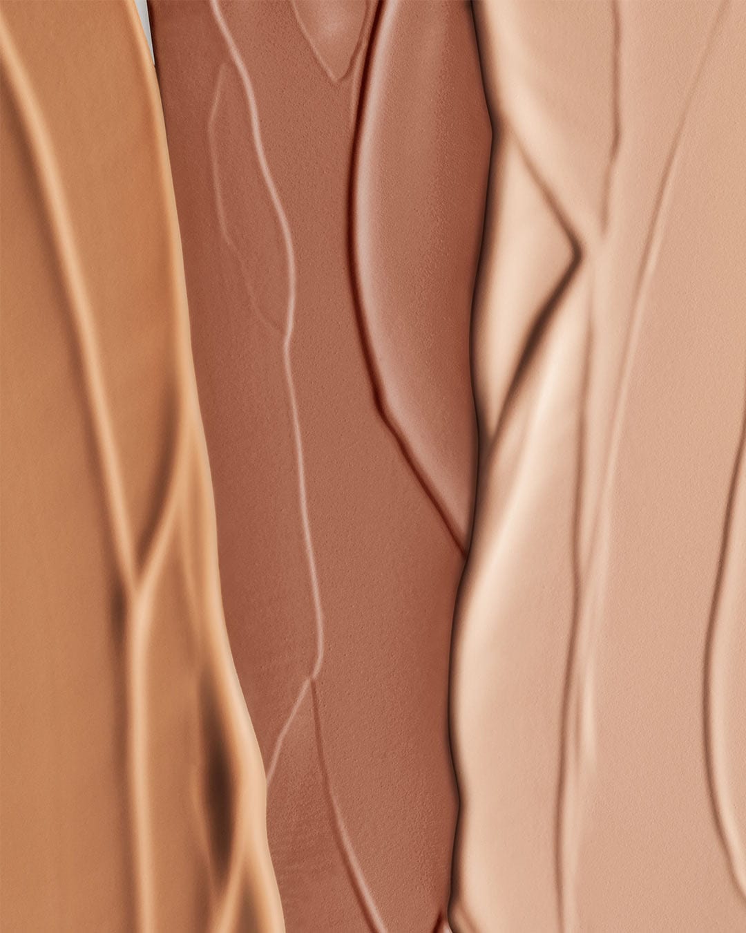 Nahaufnahme von Grundierungsfarben in verschiedenen Hauttönen, die eine Reihe von Optionen für unterschiedliche Hautfarben zeigen.