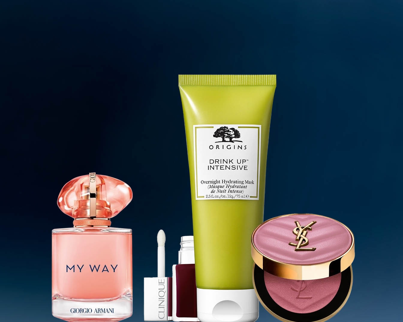 Różnorodność produktów kosmetycznych, w tym perfumy Giorgio Armani My Way w różowym flakonie, maska nawilżająca Origins Drink Up Intensive w zielonym opakowaniu i róż do policzków YSL z logo.