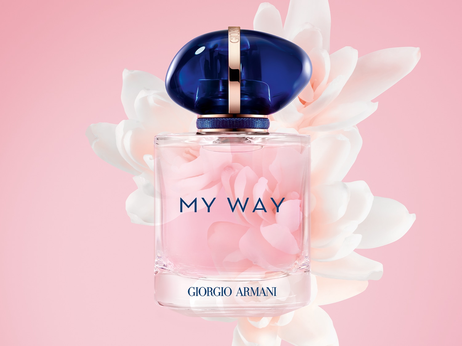 A Giorgio Armani My Way parfüm üvegben, kék kupakkal, rózsaszín virágokkal a háttérben.