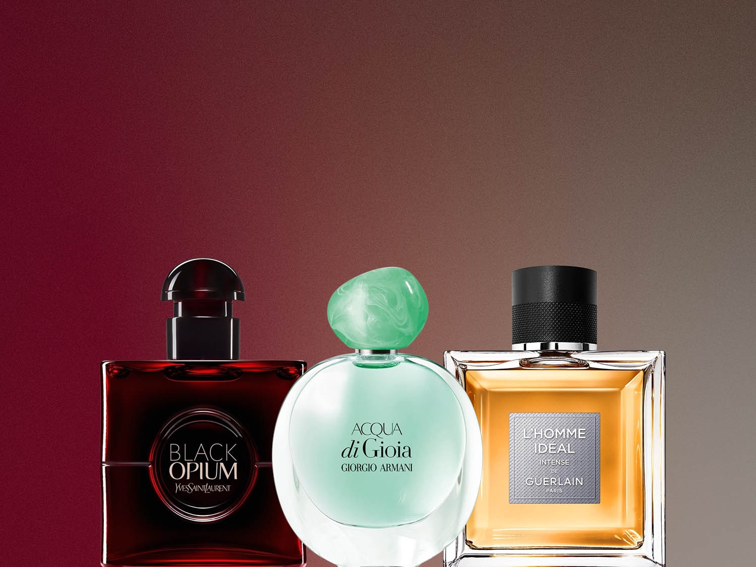 Trzy flakony perfum: Black Opium Yves Saint Laurent w ciemnoczerwonym flakonie, Acqua di Gioia Giorgio Armani w okrągłym, zielonym flakonie i L'Homme Idéal Guerlain w kwadratowym, bursztynowym flakonie.
