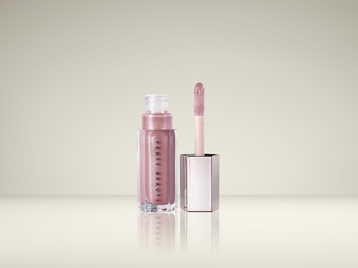 De Fenty Beauty Gloss Bomb Universal Lip Luminizer in de kleur Fenty Glow is een glanzende lipgloss met een applicator die klaar is voor gebruik.