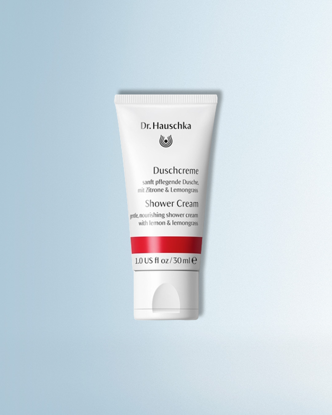 Die Dr. Hauschka Duschcreme in einer weißen Tube mit rotem Streifen, angereichert mit Zitrone und Zitronengras, bietet eine sanfte und pflegende Duscherfahrung in einer Größe von 30 ml.