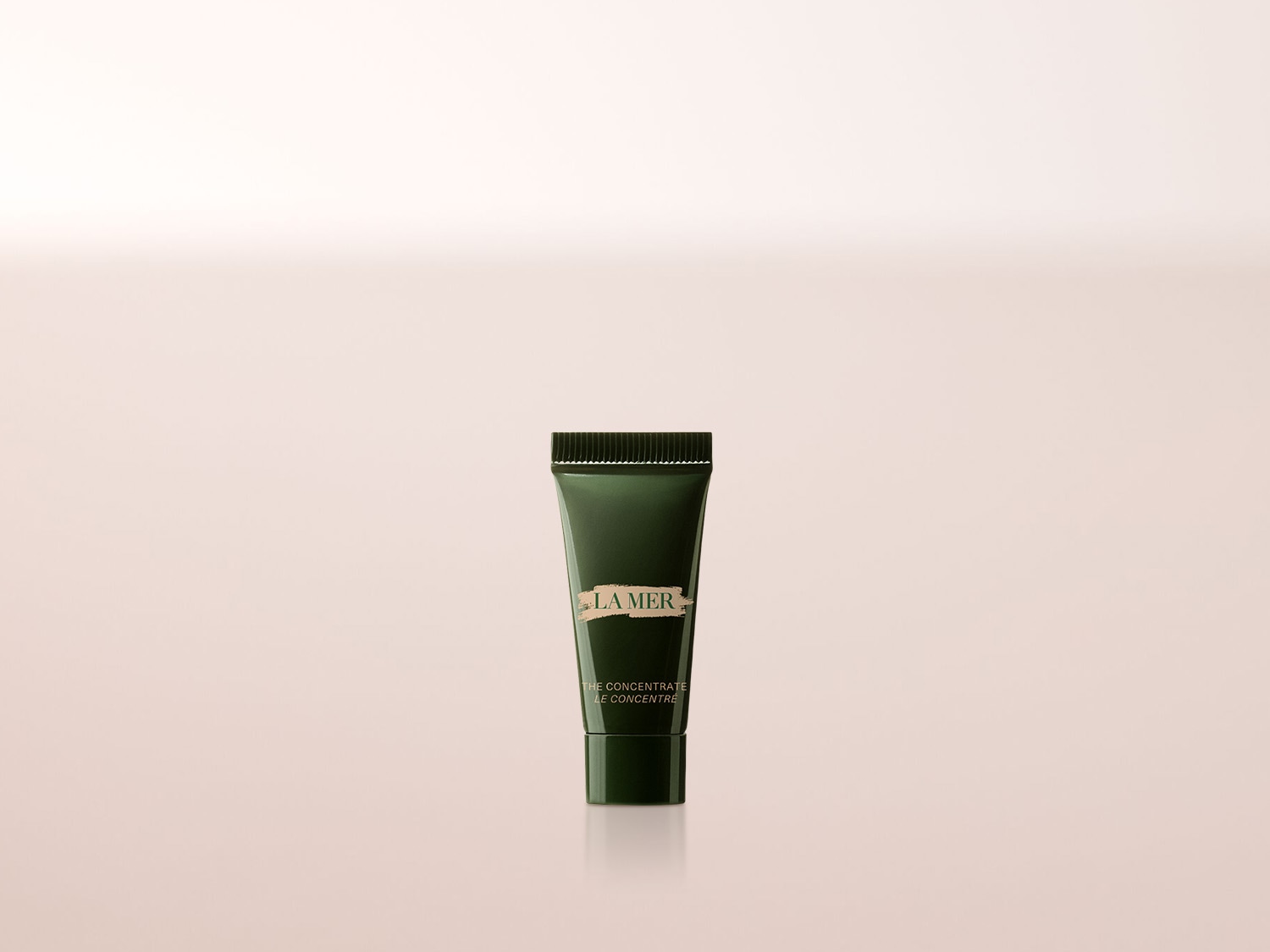 Die dunkelgrüne Tube von La Mer The Concentrate mit goldener Schrift ist ein luxuriöses Serum, das die Haut beruhigt und stärkt.