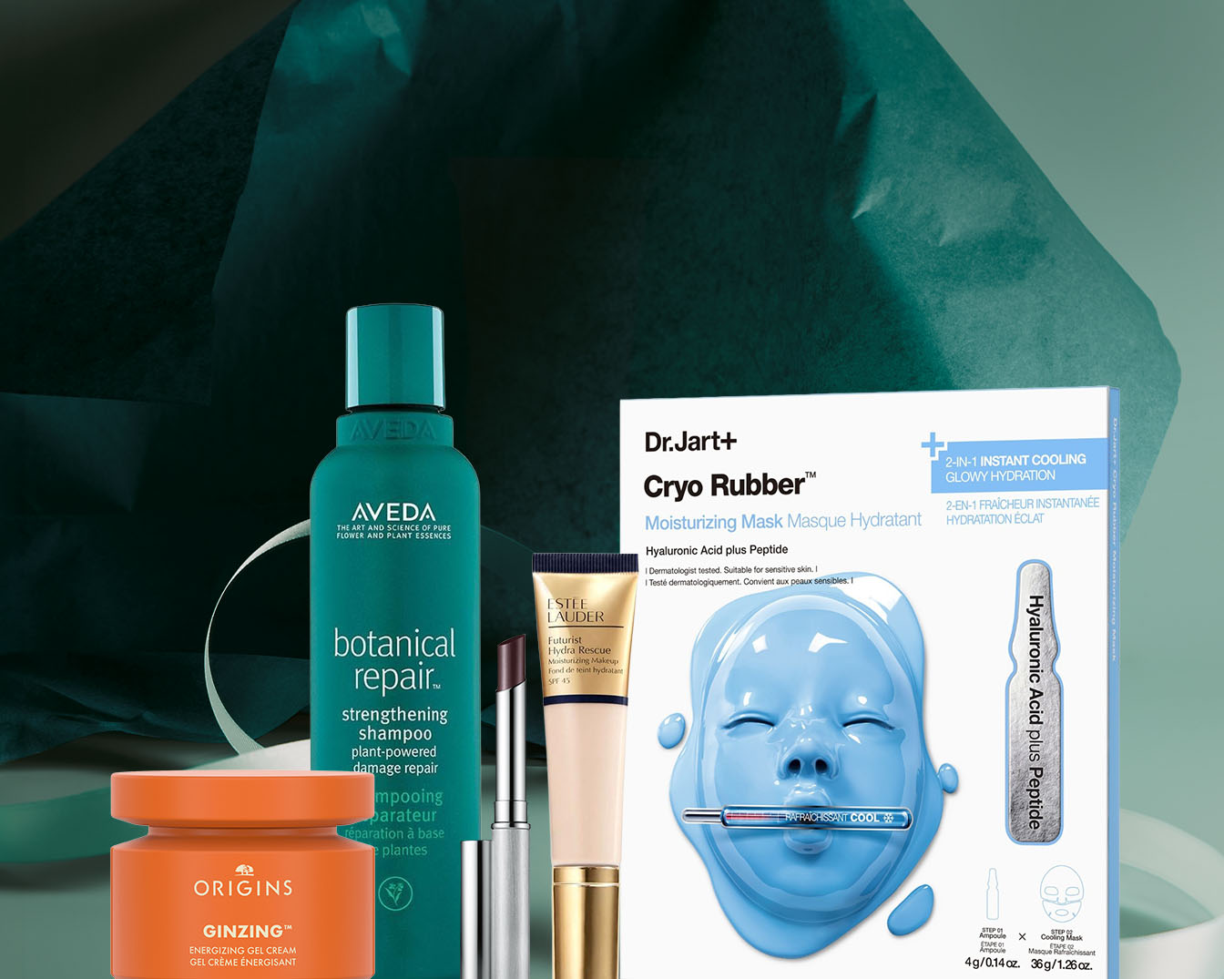 Zestaw różnych produktów kosmetycznych, w tym pomarańczowy słoiczek kremu Origins Ginzing, zielona butelka szamponu Aveda Botanical Repair, pomadka Estee Lauder oraz maseczka w płachcie Dr.Jart+ Cryo Rubber z kwasem hialuronowym. Odkryj ulubione kosmetyki i zamów już teraz!